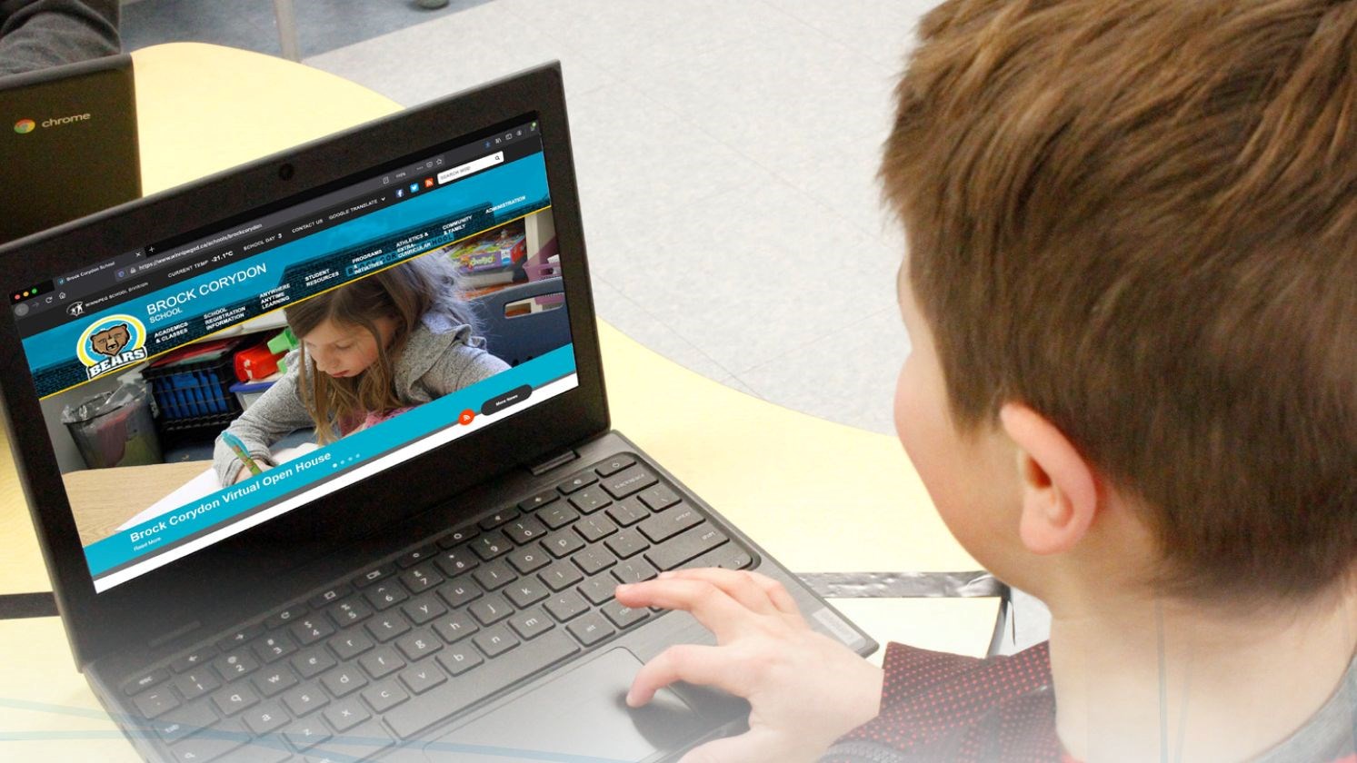 Student looking at a chromebook browsing the Brock Corydon website